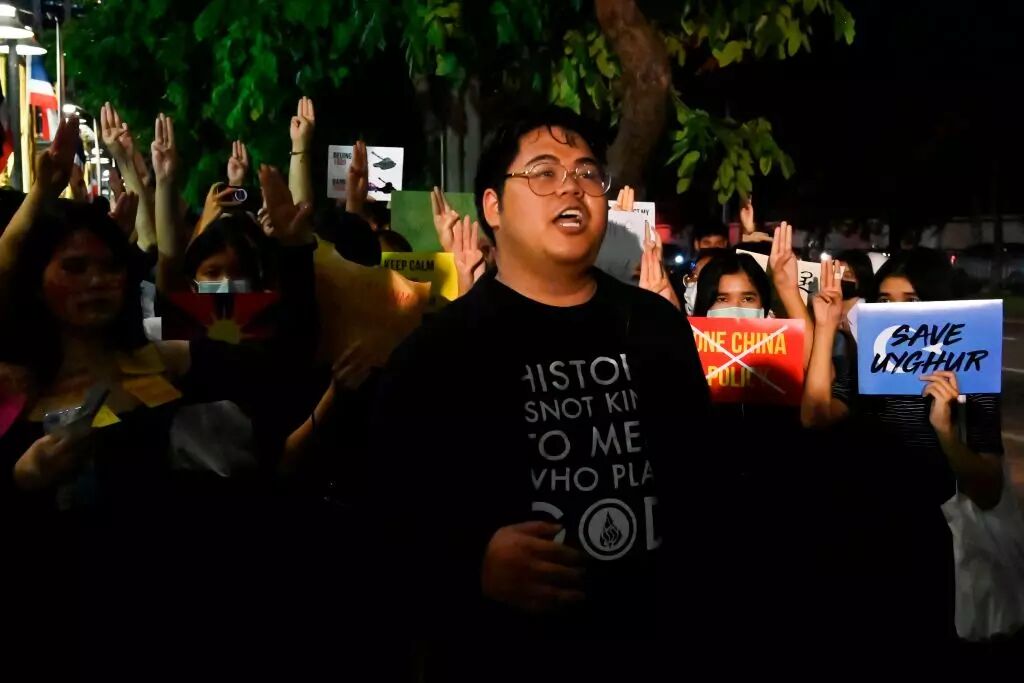 A student shout slogans as other hold placards during a Milk Tea Alliance anti-China protest outside the Chinese embassy in Bangkok on October 1, 2020